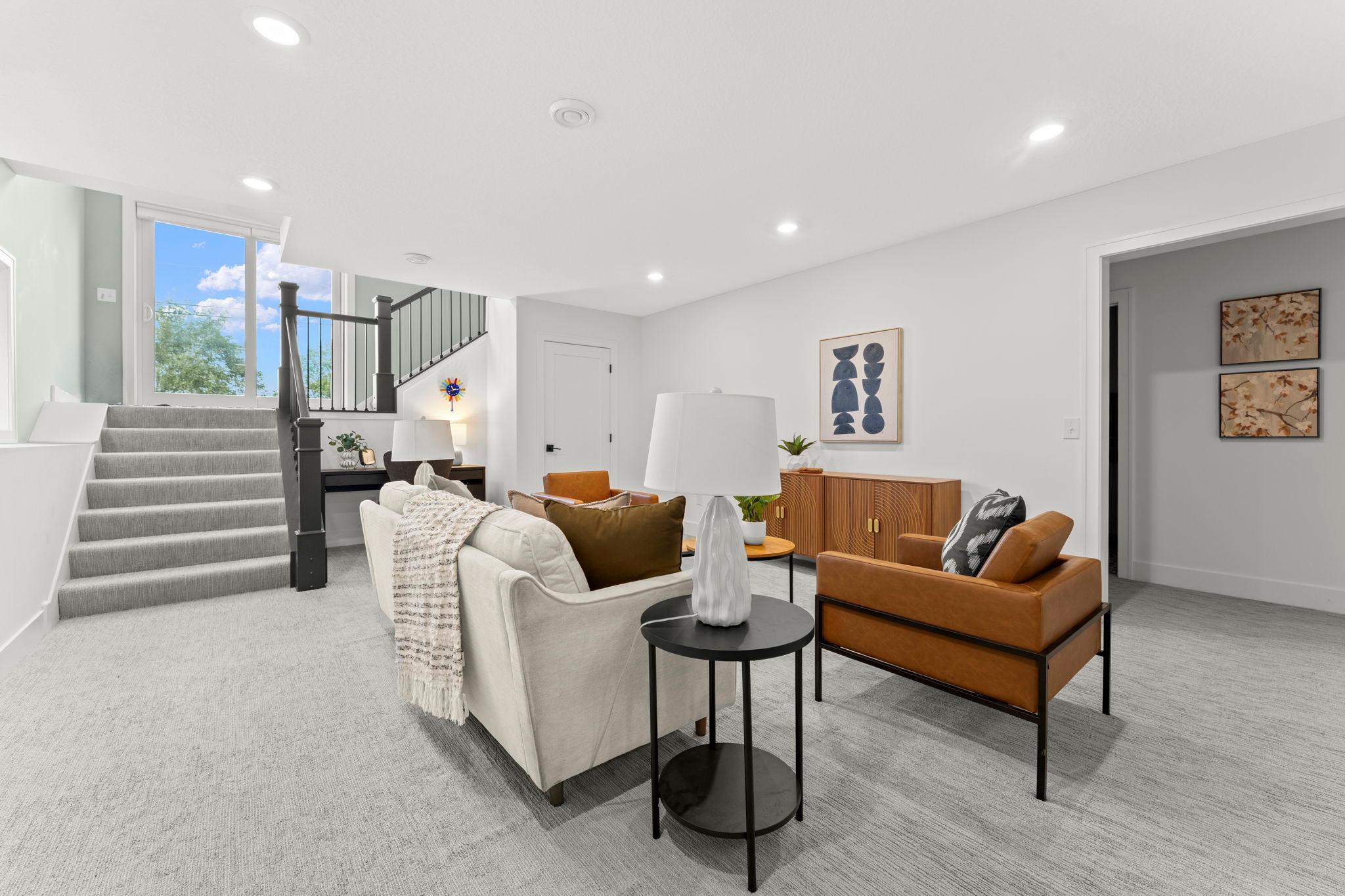 The open lower level offers multiple seating areas and abundant natural light