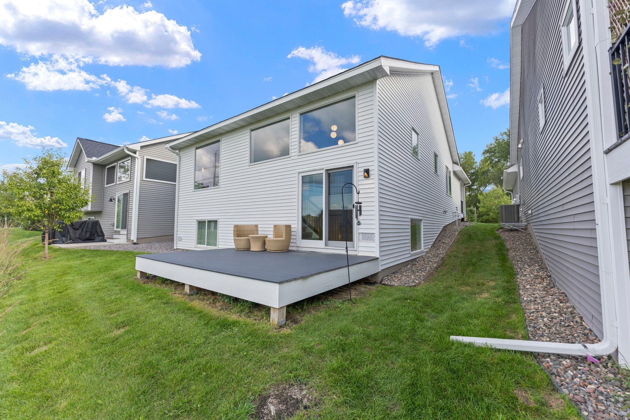 Rear exterior with a maintenance free deck overlooking the backyard