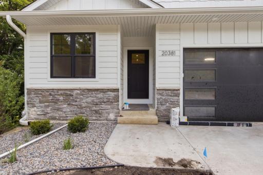 Photo of similar model - gorgeous landscaping greeting you!