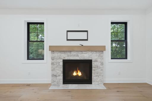 Photo of similar model - gorgeous fireplace on main level