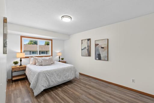 Spacious primary bedroom with new flooring