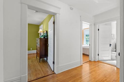 View from 2nd floor landing into primary bedroom on the left and 2nd bedroom on the right.