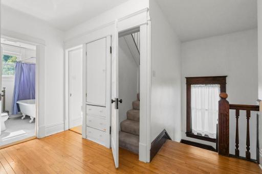 This is the landing on the 2nd floor. To the right are the stairs back down to the main floor. Through the door are the stairs to the 3rd floor. There is a linen closet to the left of these stairs.