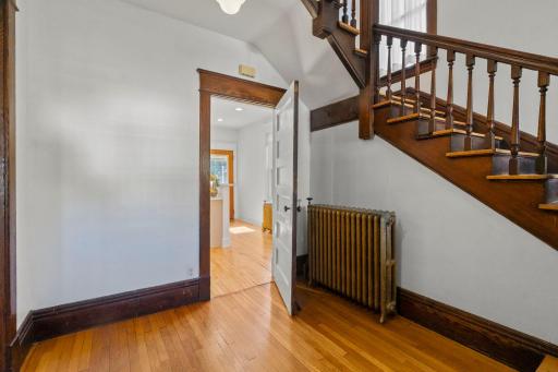 View from the front entry into the hall and into the kitchen through the door straight ahead.