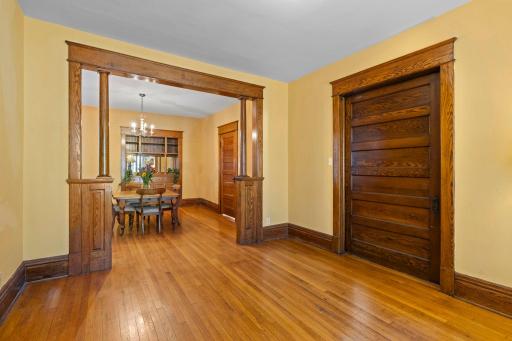This is a view from the living room into the dining room on the left. Notice the pocket door on the right between the living room and the front hall.