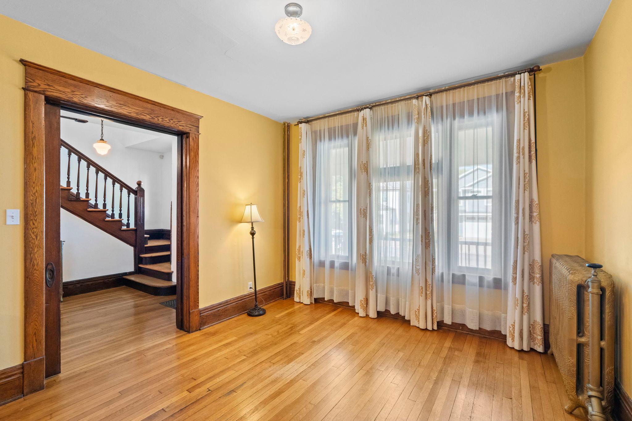 Living room front windows. The wood behind these curtains is beautiful.