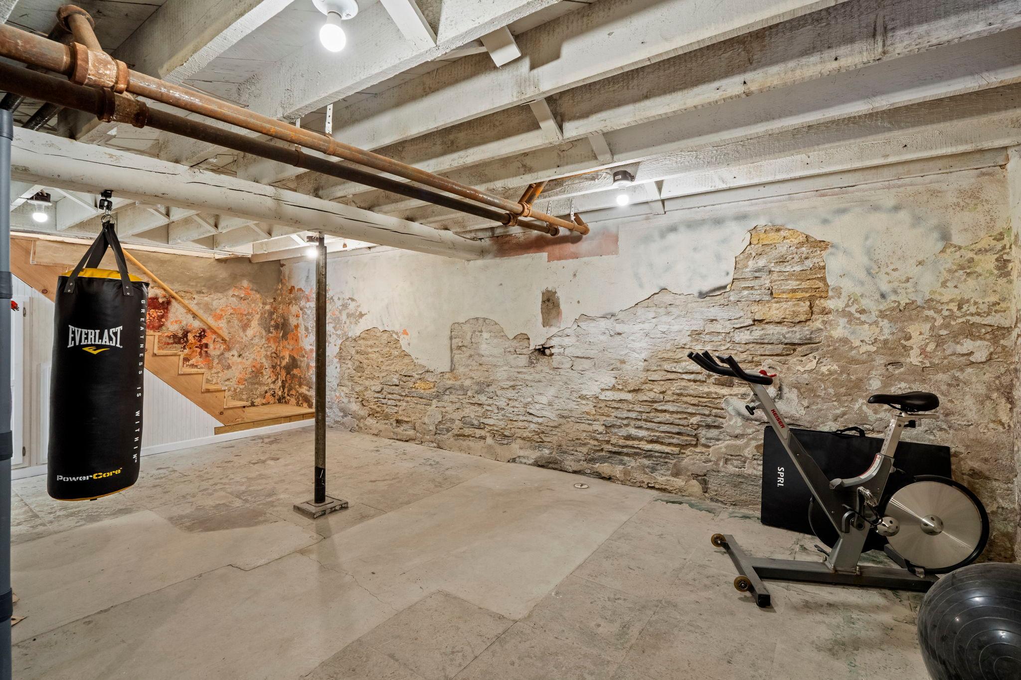 There is lots of space in this basement. The seller used this as a workout space.