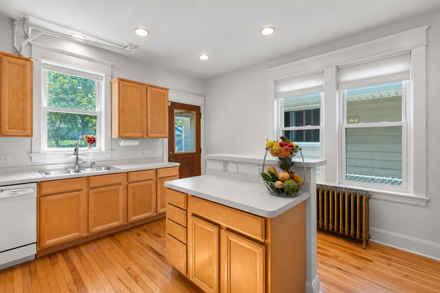 The kitchen is bright, clean and has lots of light.