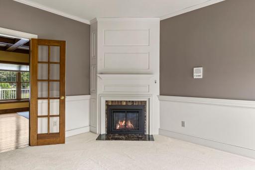 Beautiful fireplace with stone surround and beautiful woodworking.
