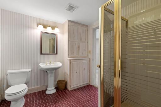 3/4 Bathroom on the lower level with cabinet storage.