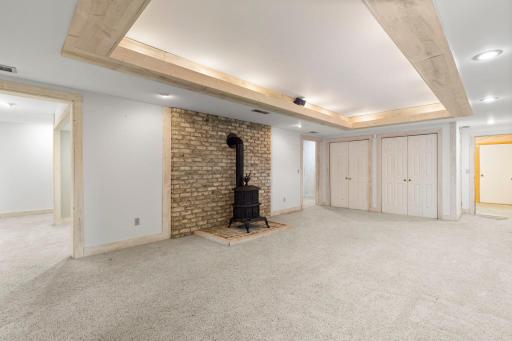 The lower level family room comes complete with a gas fireplace with a high-end Hearth and Home insert, set within a masonry surround.