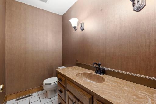 The powder bath is located right between the mudroom and the living room, with easy access to the main level as well as the attached garage.