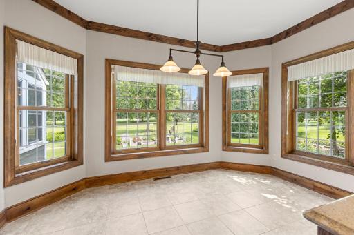Views spanning over the back and side yard, flooding the room with natural light.