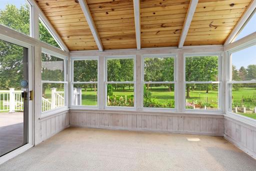 Three-season porch complete with windows, vaulted ceiling, and access to the maintenance-free deck.