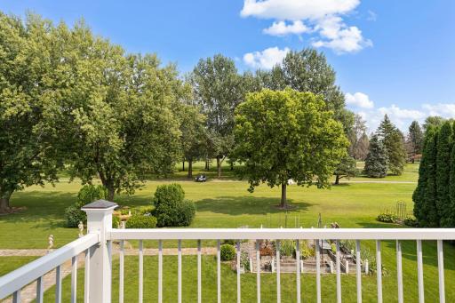 View from the primary bedroom balcony spanning over the golf course.