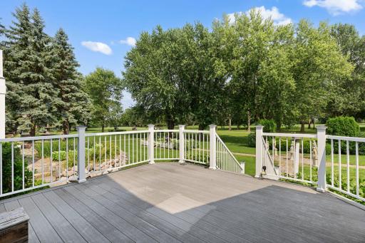 Deck overlooking the backyard, with views of the golf course.
