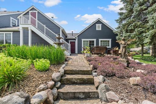 Stunning stone stairs and landscaping leading the the backyard.