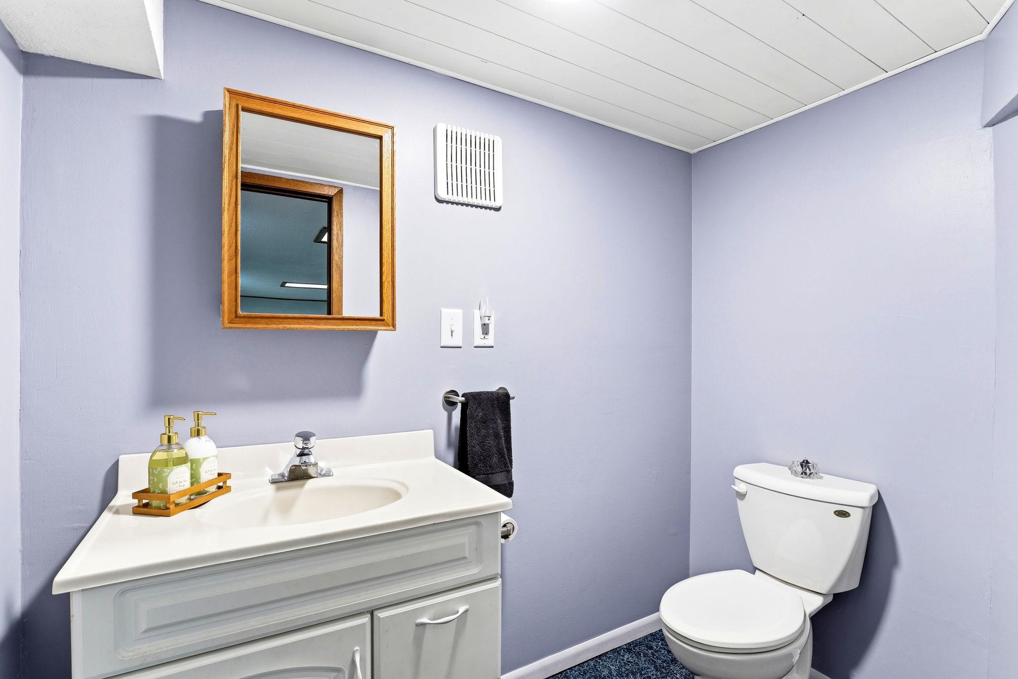 Lower-level half bath for convenient everyday use.