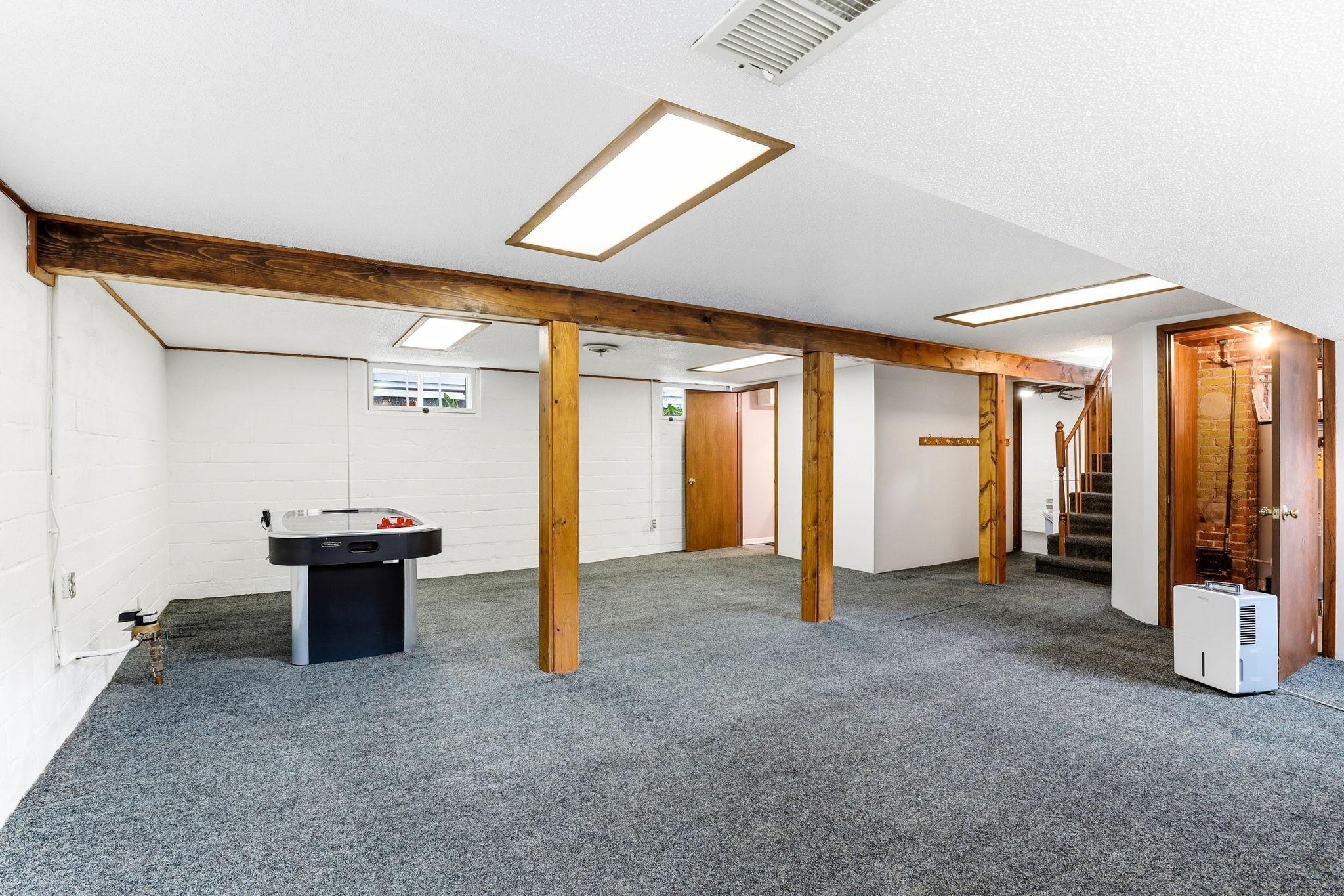 Expansive lower-level family room with flexible space for multiple uses.