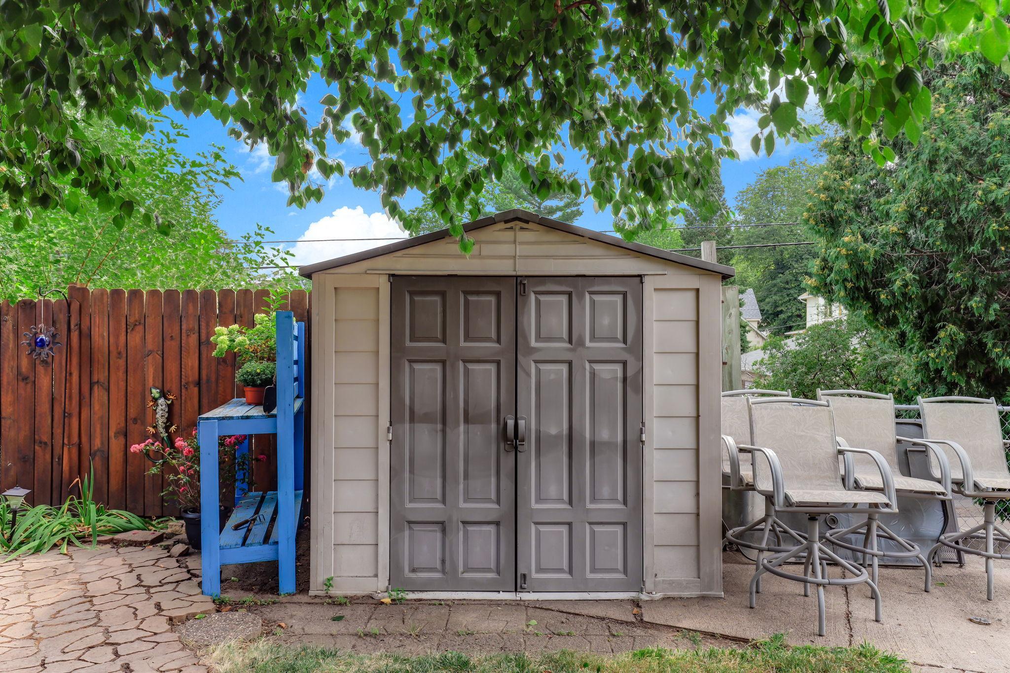 Detached storage shed adds valuable space for yard essentials.