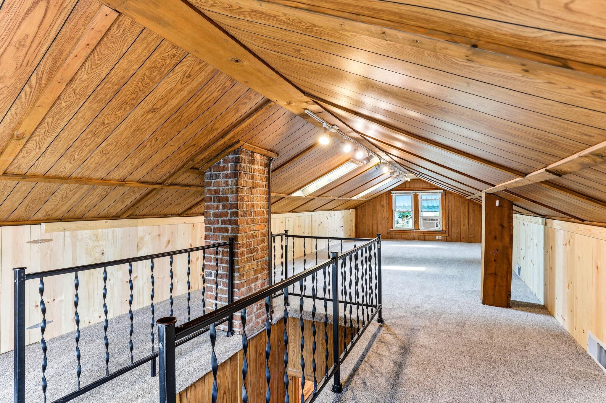 Upper-level third bedroom offering a quiet, private retreat with generous natural light and flexible use.