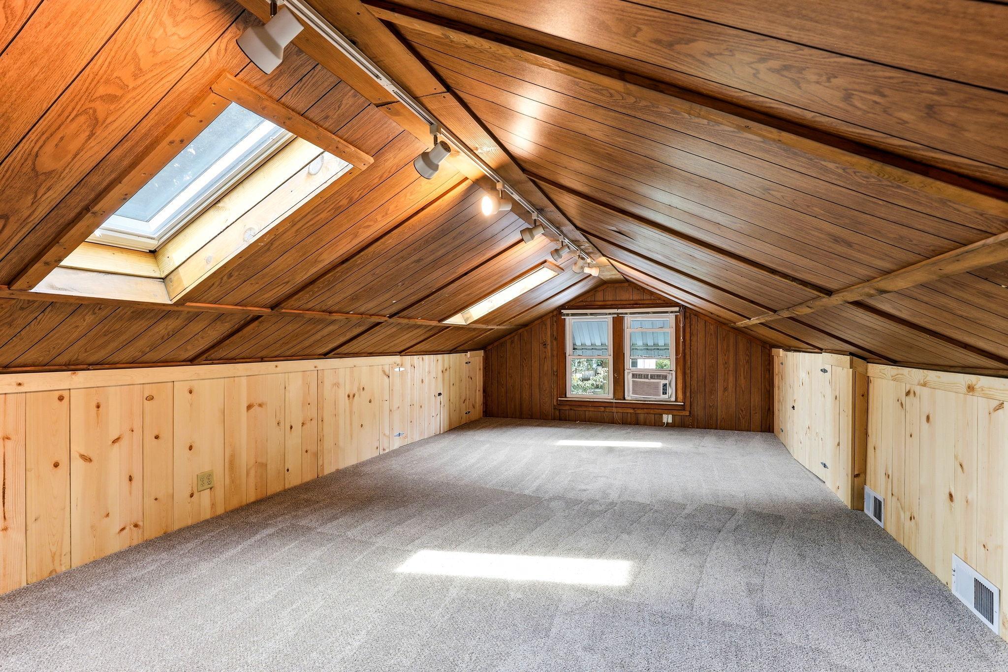 New carpet in the upper-level third bedroom adds a soft, refreshed feel and enhances the room’s cozy retreat vibe.