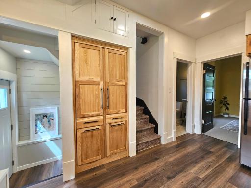 SW back entry leads to both basement and main floor. Note the storage above the pantry.