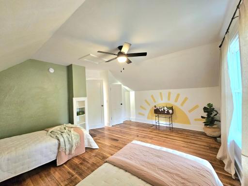 Built in bookshelf & Naive Folk Art inspired wall mural add to the charm of this room!