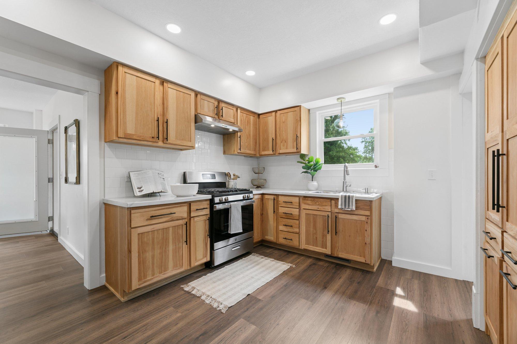 Kitchen ceiling, lighting, flooring, walls, cabinets, countertop and sink all NEW!