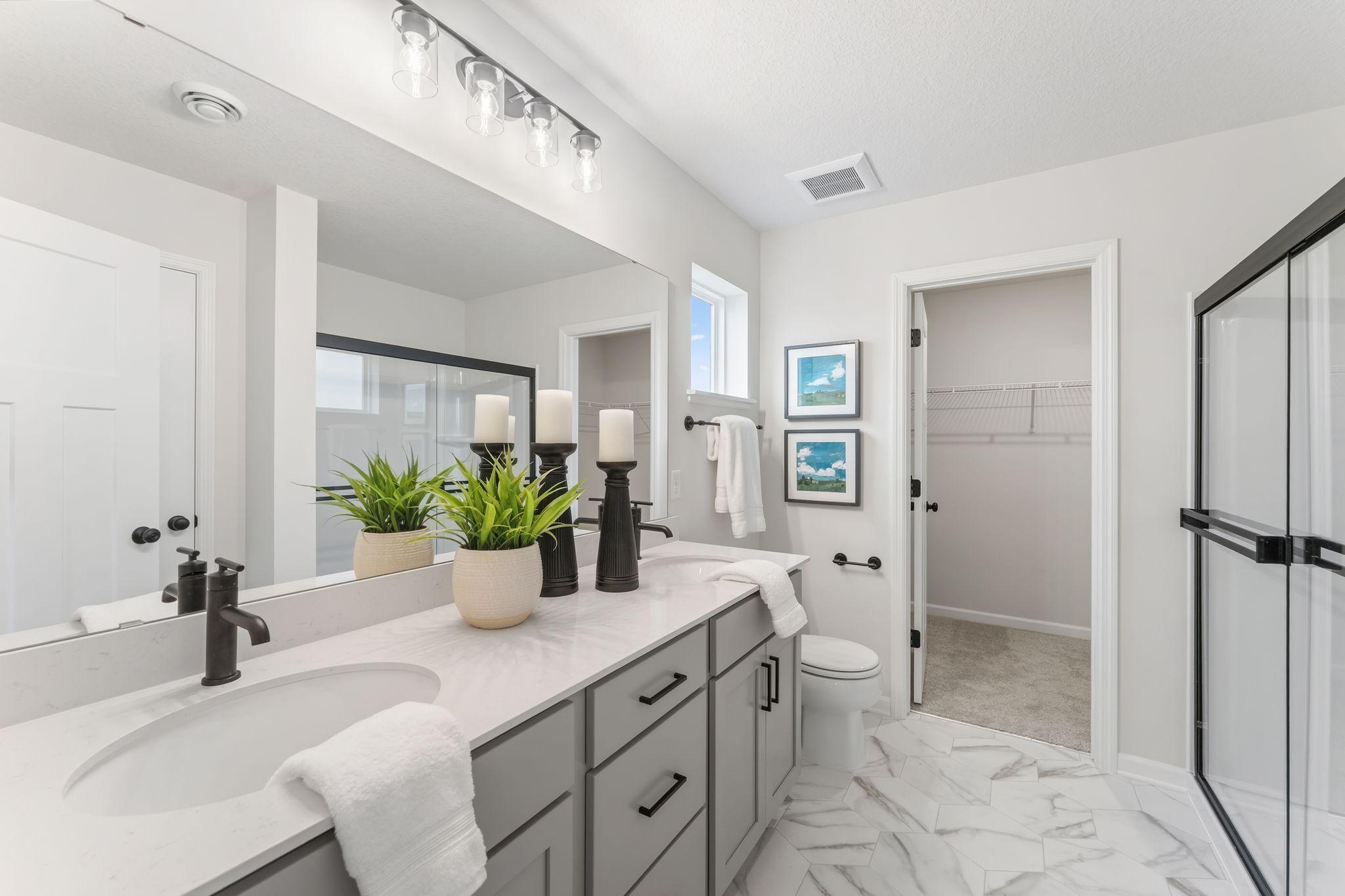 Raised vanity double bowl sink, soft close cabs/drawers, low-curb shower, stylish floor & lighting, & spacious walk-in closet! (Picture for representation only, colors & materials may vary in actual home.)