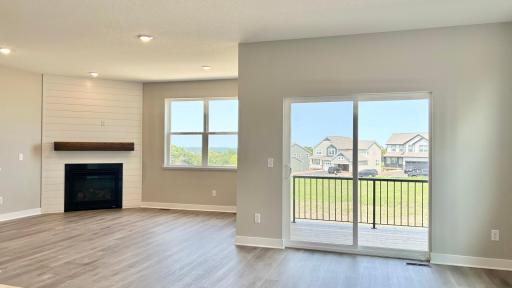 Spacious and sunny dining space open to the covered deck and living room. Photo of actual home.