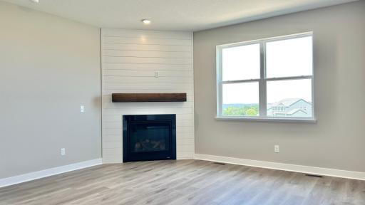 Living room with cozy gas fireplace and panoramic bluff views. Photo of actual home.