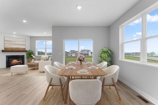 Spacious and sunny dining space leading to the covered deck with panoramic views. Photo of actual home.