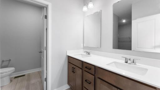 Private primary bath with dual sinks. Photo of actual home.