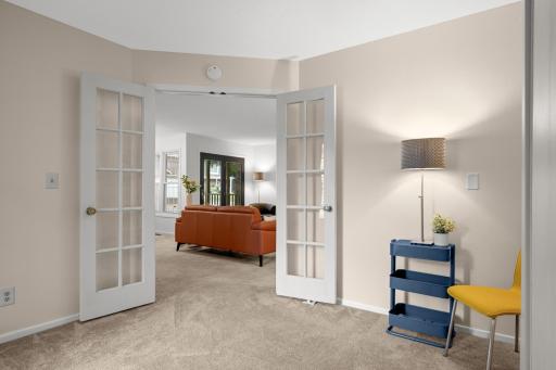 French doors open to a versatile bonus space ideal for a home office, den, reading room, or additional sitting area.