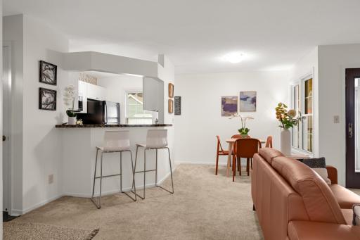 Open-concept main level connects the living room, dining area, breakfast bar, and kitchen for easy everyday living and entertaining.