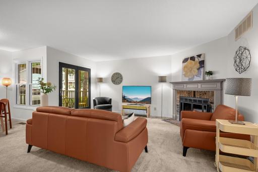 Large windows and direct access to the covered porch bring natural light into this comfortable living room.