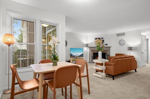 A great view of the open floor plan, showing the natural connection between the dining area, living room, fireplace, and covered porch.