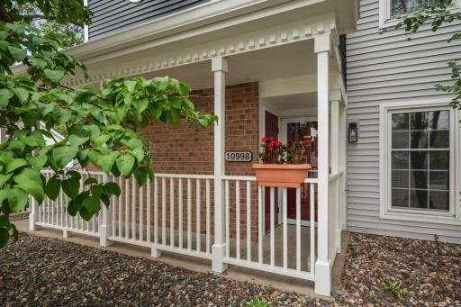 Charming covered front porch creates a welcoming entrance and offers a sheltered outdoor space to enjoy the neighborhood.