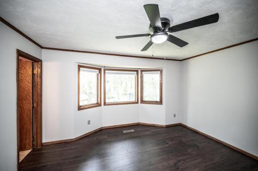 The main level primary bedroom is a nice size and has a bump-out overlooking the backyard.