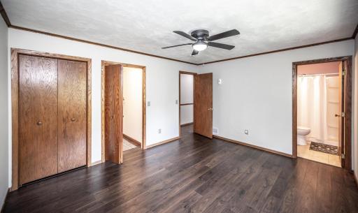 The main level primary bedroom has a walk-in closet as well as a second closet with bi-fold doors. It also leads to the 3/4 primary bathroom.