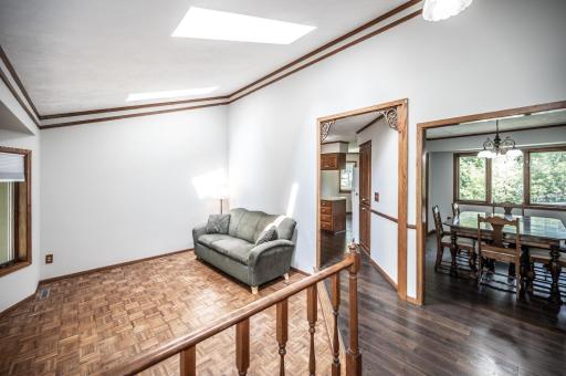 Living room inside the front entry leads to the kitchen and the formal dining room