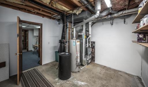 Spacious utility room with a newer furnace, AC and water softener