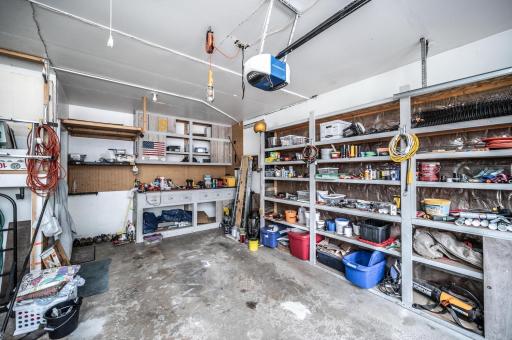 The garage has a workbench and plenty of storage shelves