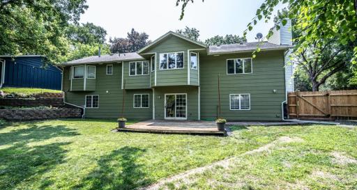 The back exterior has a nice retaining wall and a deck/patio area