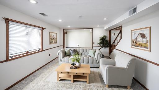 This photo has been virtually staged. The lower level family room leads to another large room just behind it, giving you versatility in how you want to use it.