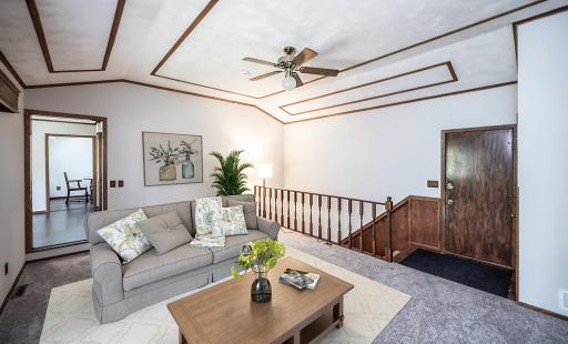 This photo has been virtually staged. Another view of the main level living area.