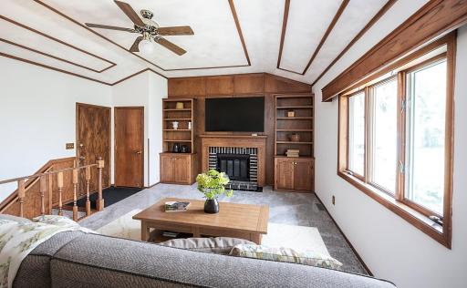 This photo has been virtually staged. Main level living area with built-in. shelving.