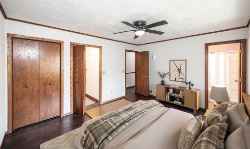This photo has been virtually staged. The main level primary bedroom has a walk-in closet as well as a second closet with bi-fold doors. It also leads to the 3/4 primary bathroom.