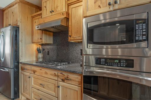 Kitchen with rustic hickory cabinets and stainless steel appliances
